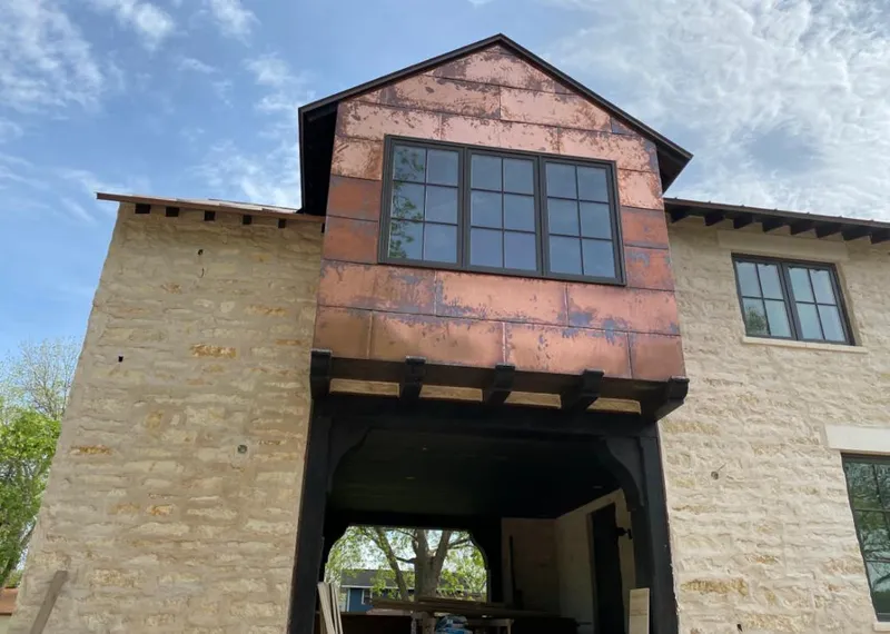 Copper metal panel facade on a stone building for Skylight Installation in Anniston