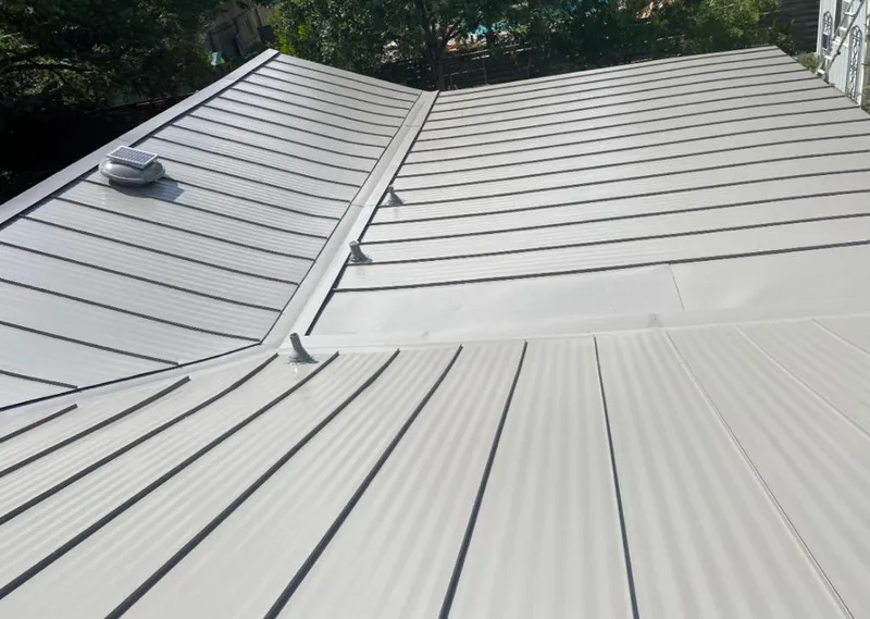 Solar attic fan installed on a metal roof for Roof Ventilation in Anniston